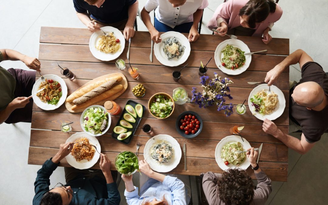 family eating around a table - navigating the holidays